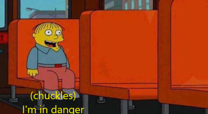 still image of the simpsons character ralph wiggums, from the simpsons family guy crossover episode. ralph is sitting on a bus seat and exclaiming "I'm in danger"