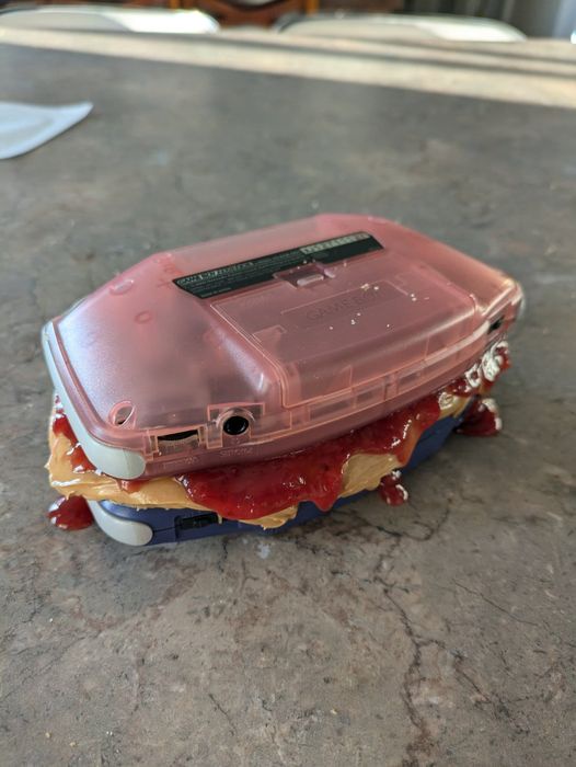 two Gameboy colors made into a peanut butter jelly sandwich 