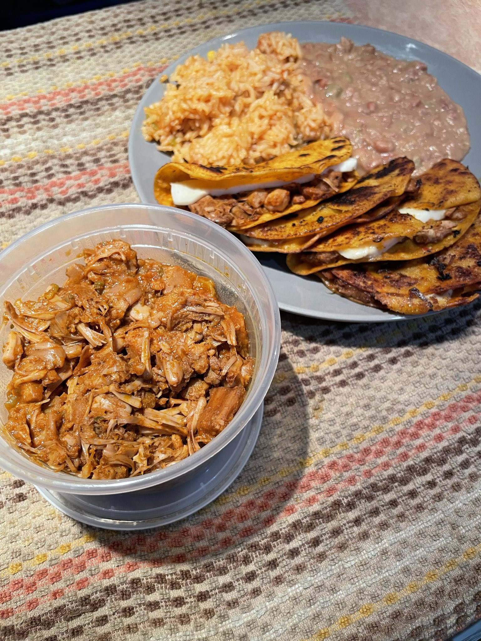 vegan Quesabirria, rice and beans next to a tub of my vegan, jackfruit birria.