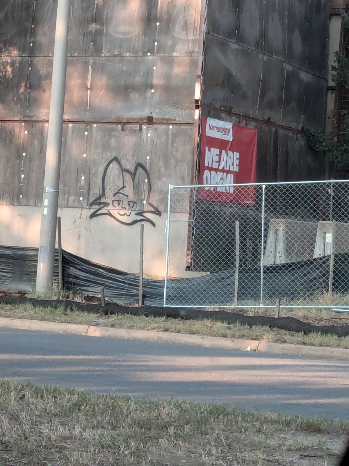 Boykisser fella spray painted onto a construction wall.